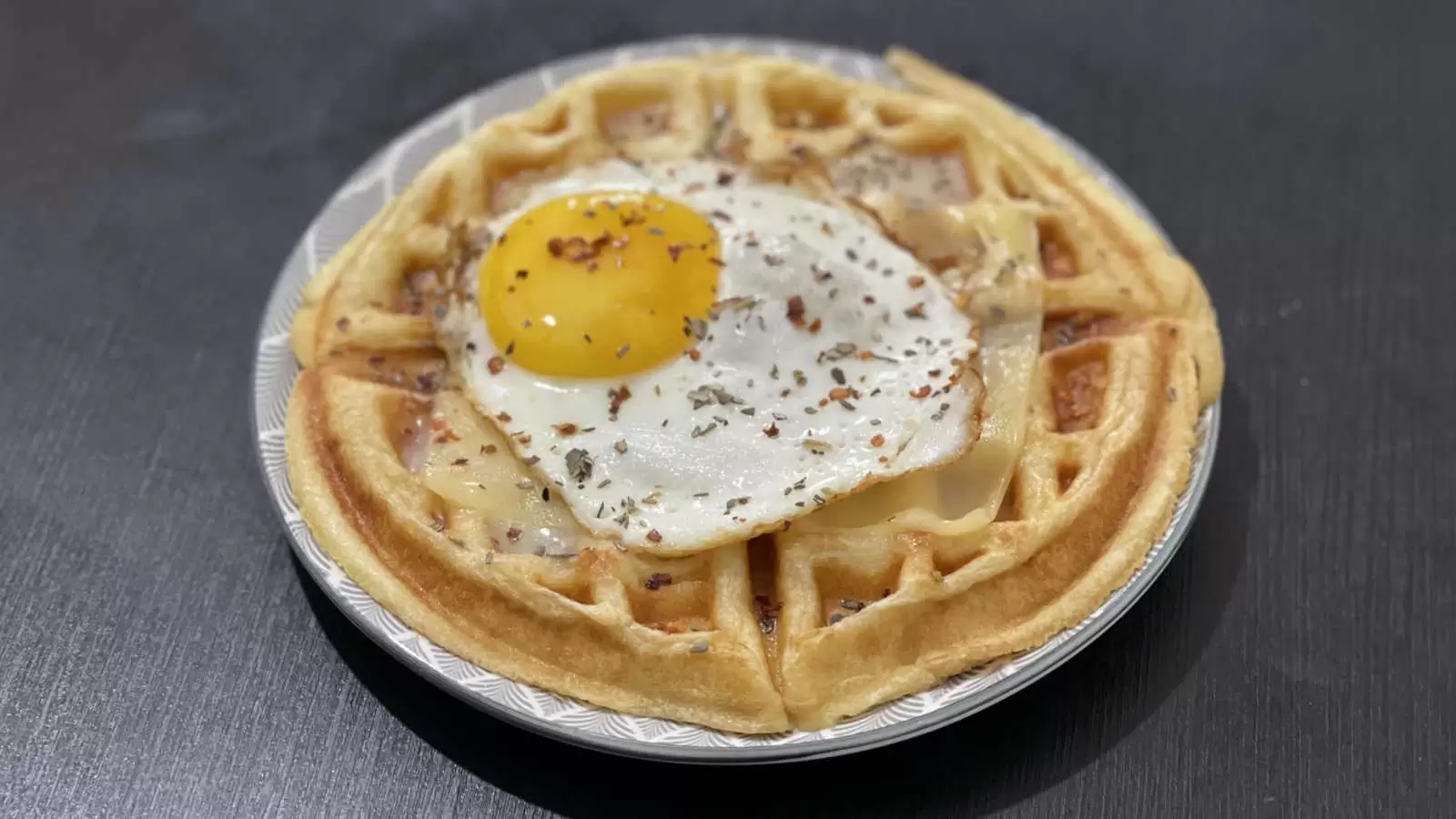 Belgian waffle with egg and cheeses dish