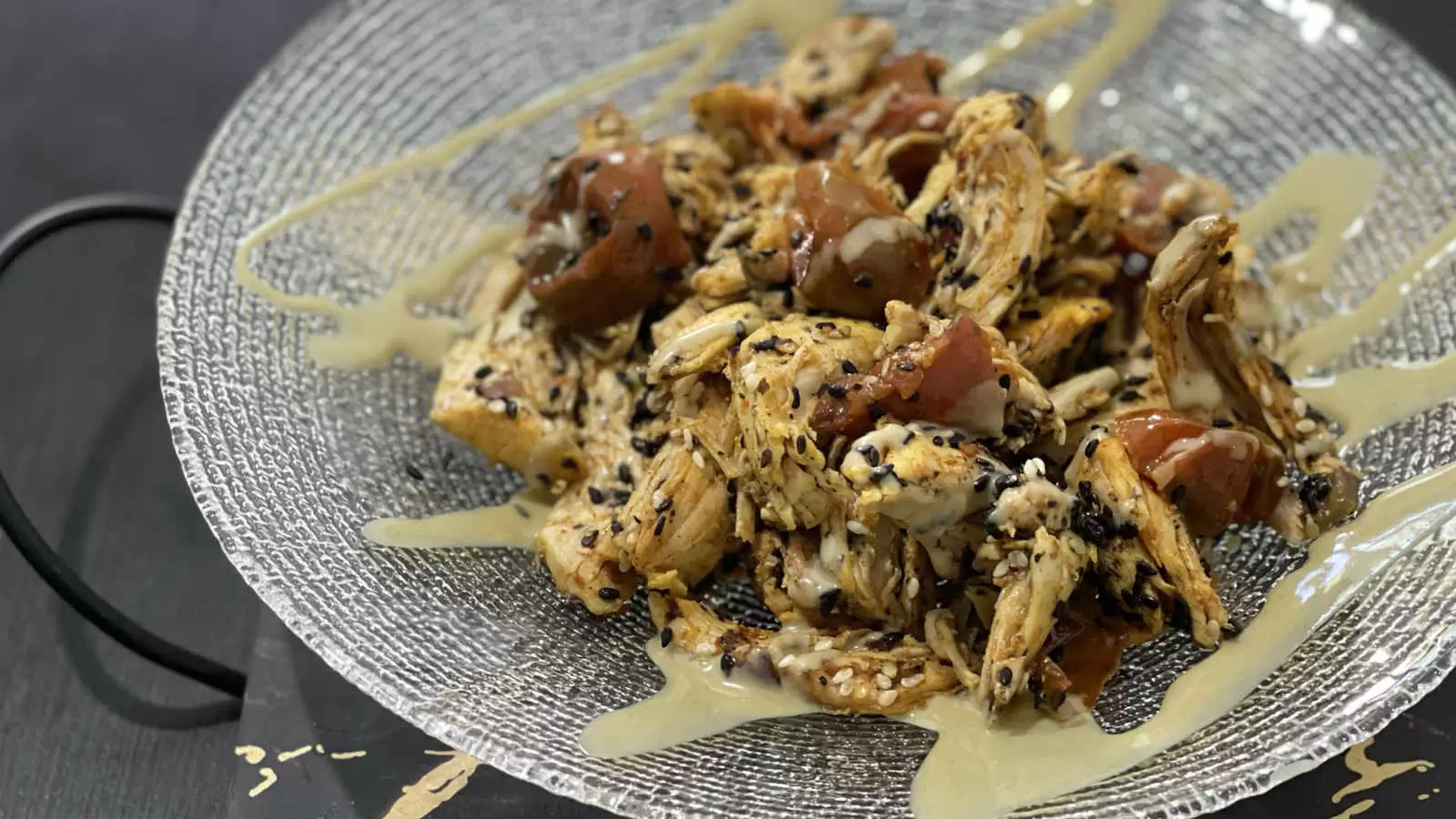 A dish of Chicken stir fry with tomatoes and onion on a plate