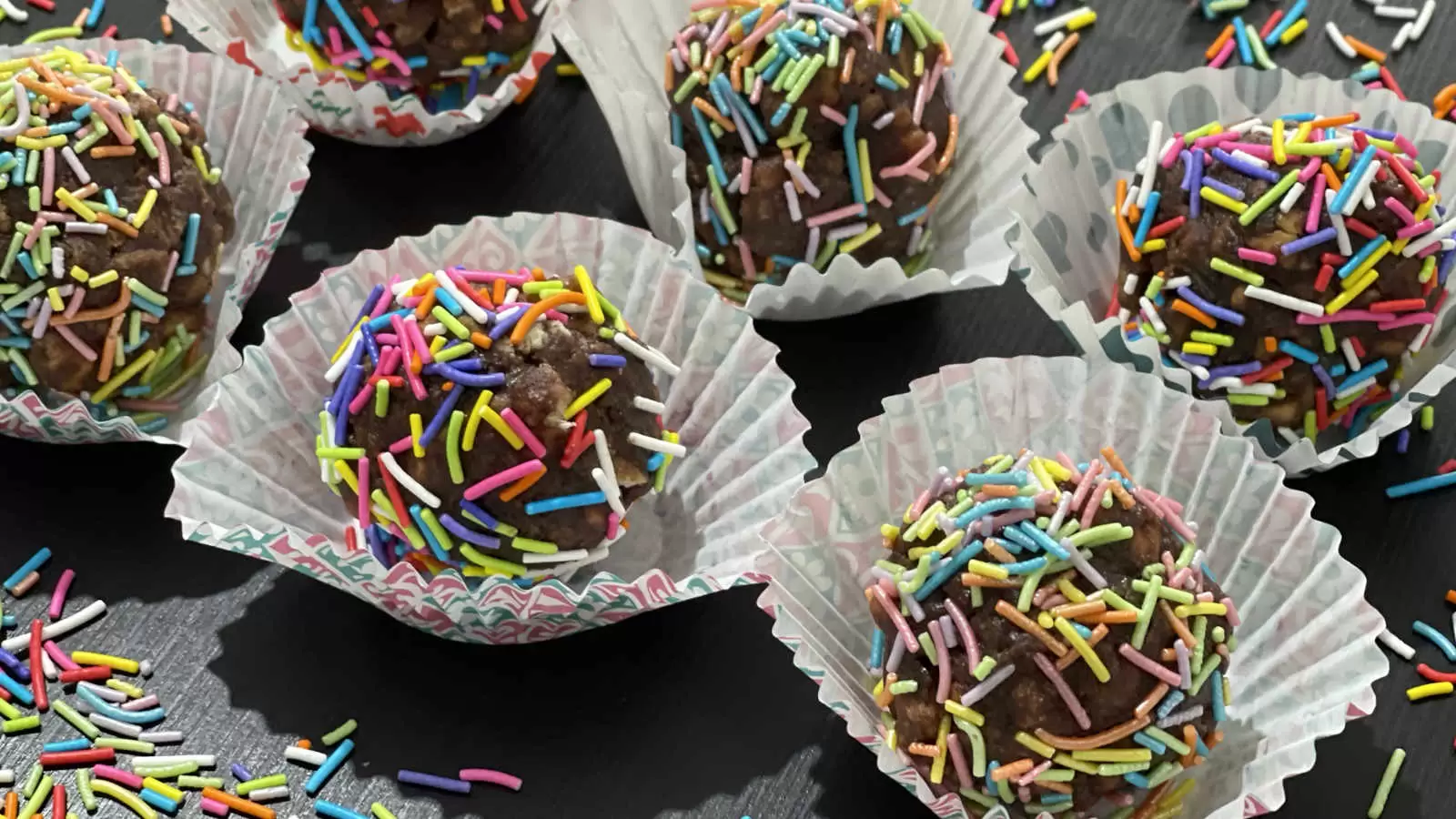 Chocolate balls with rainbow sprinkles in baking cups