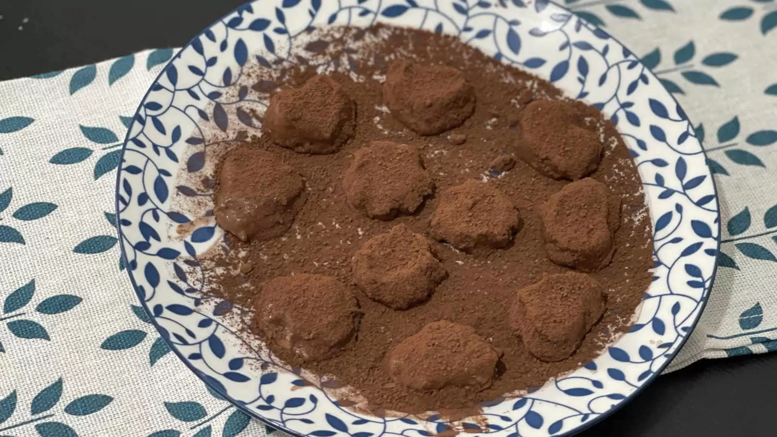 Chocolate banana truffles on a plate and under a napkin