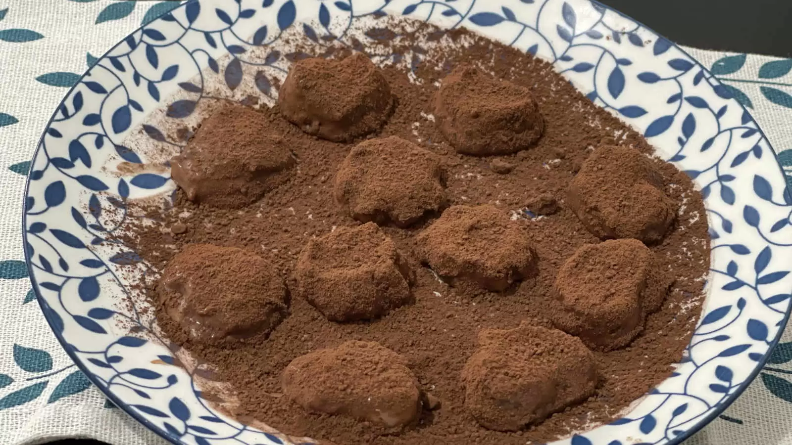 Chocolate banana truffles dish on a plate and under a napkin