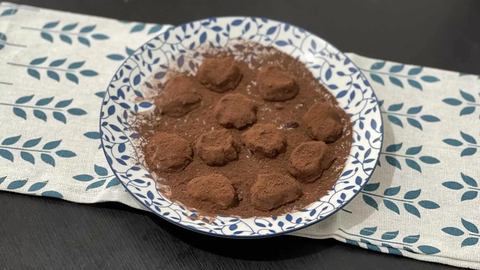 Chocolate banana truffles recipe on a plate and under a napkin