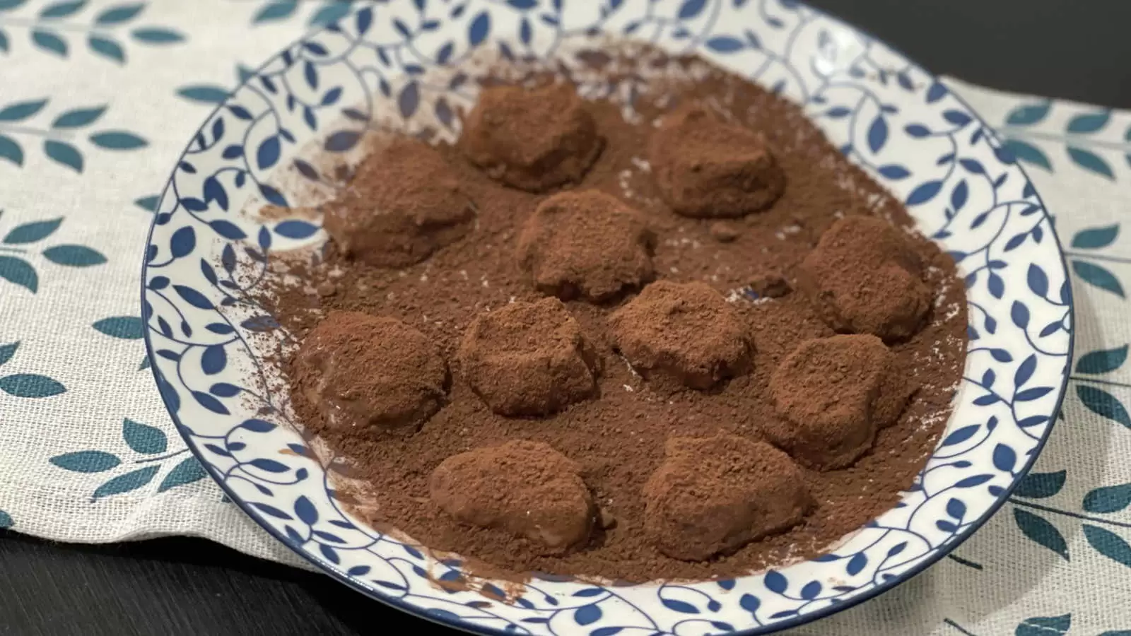 Chocolate banana truffles on a plate and under a napkin