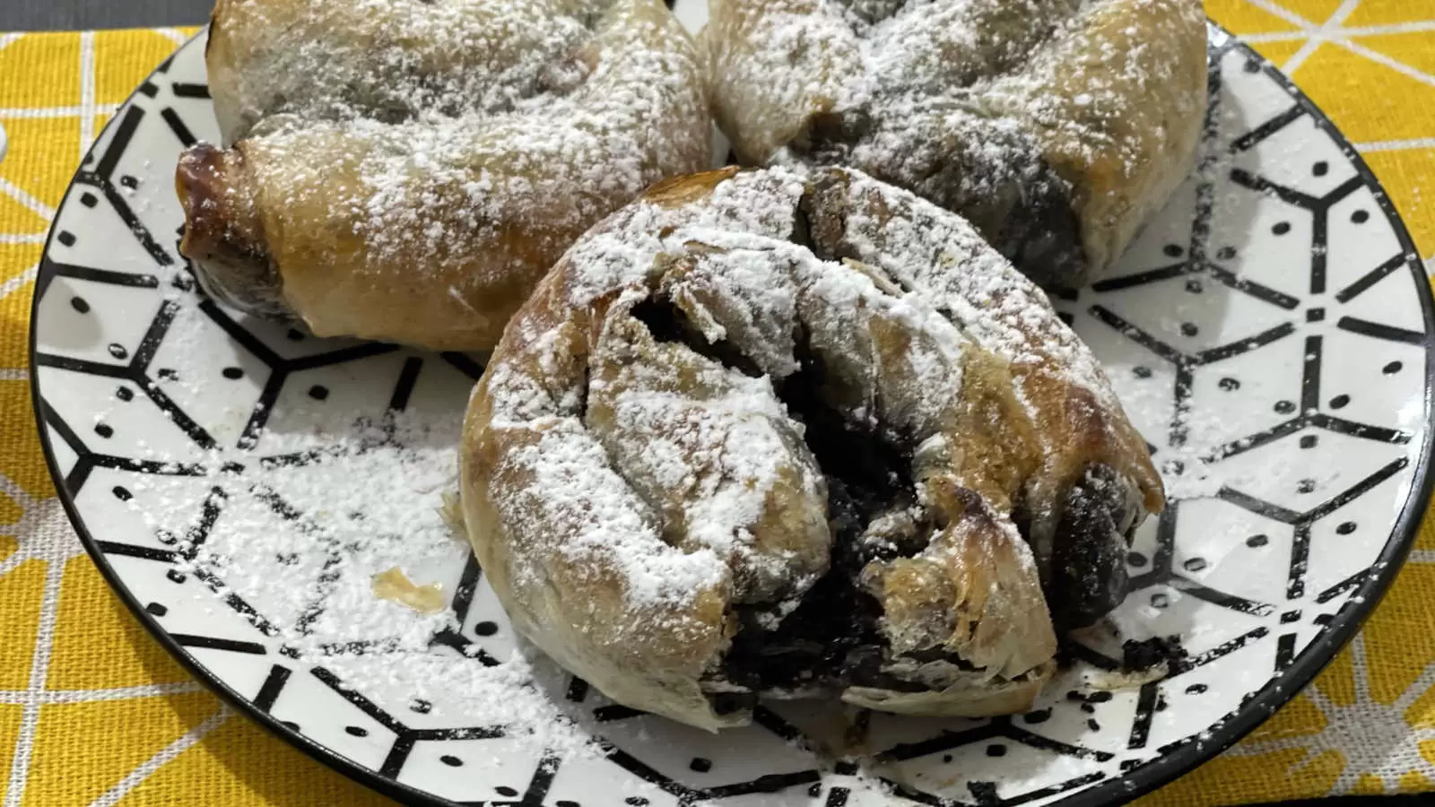 Three Chocolate rice paper on a plate under a yellow napkin