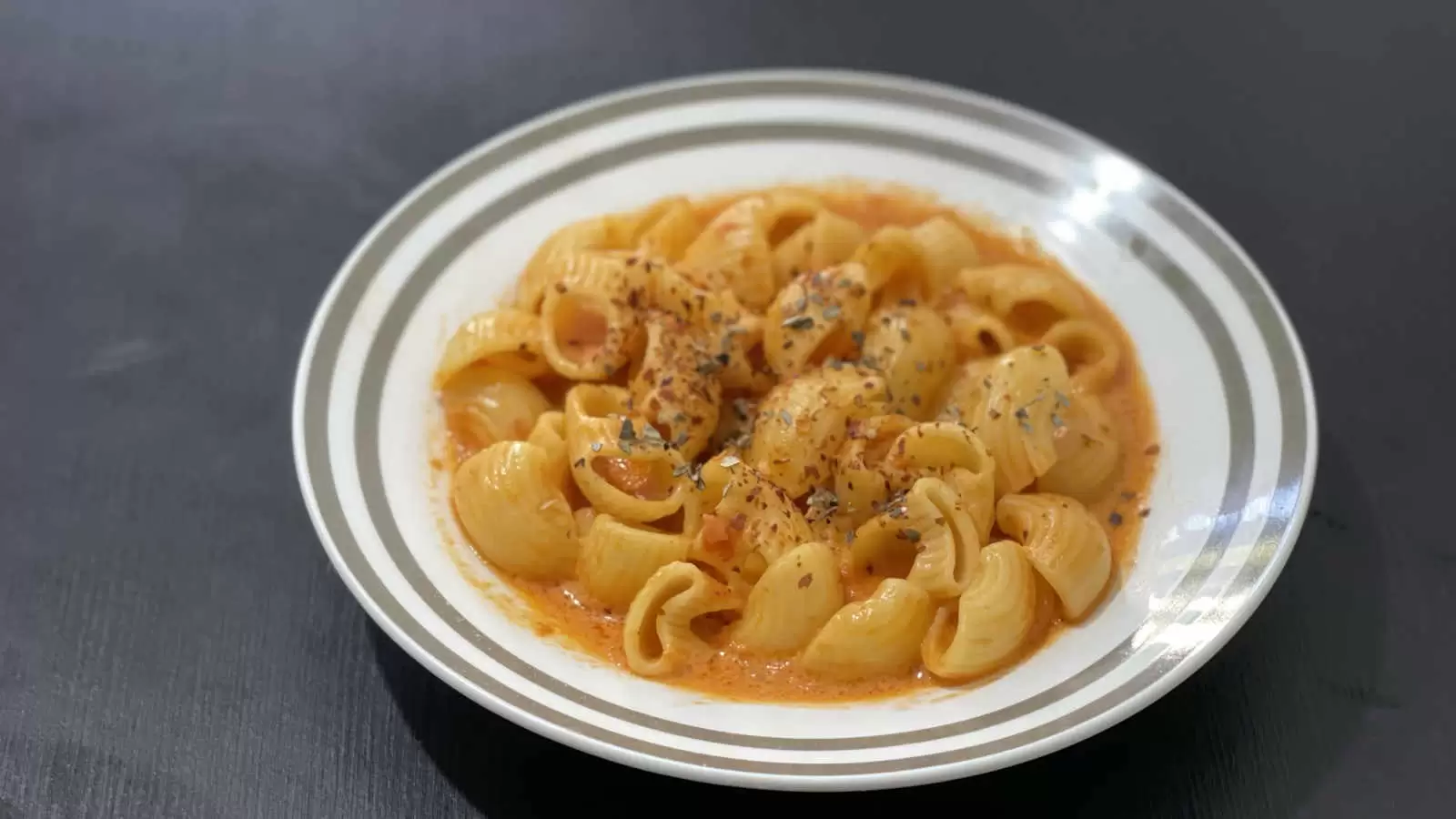 Creamy Tomato Pasta recipe in a plate on a table