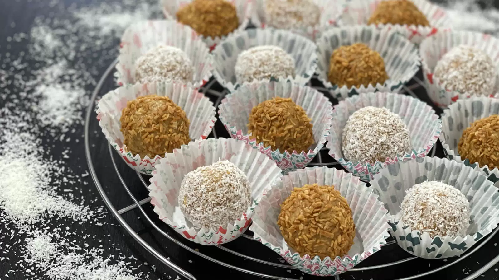 Delicious Milk Jam Balls with Biscuits on a grid coconut flakes scattered on the table