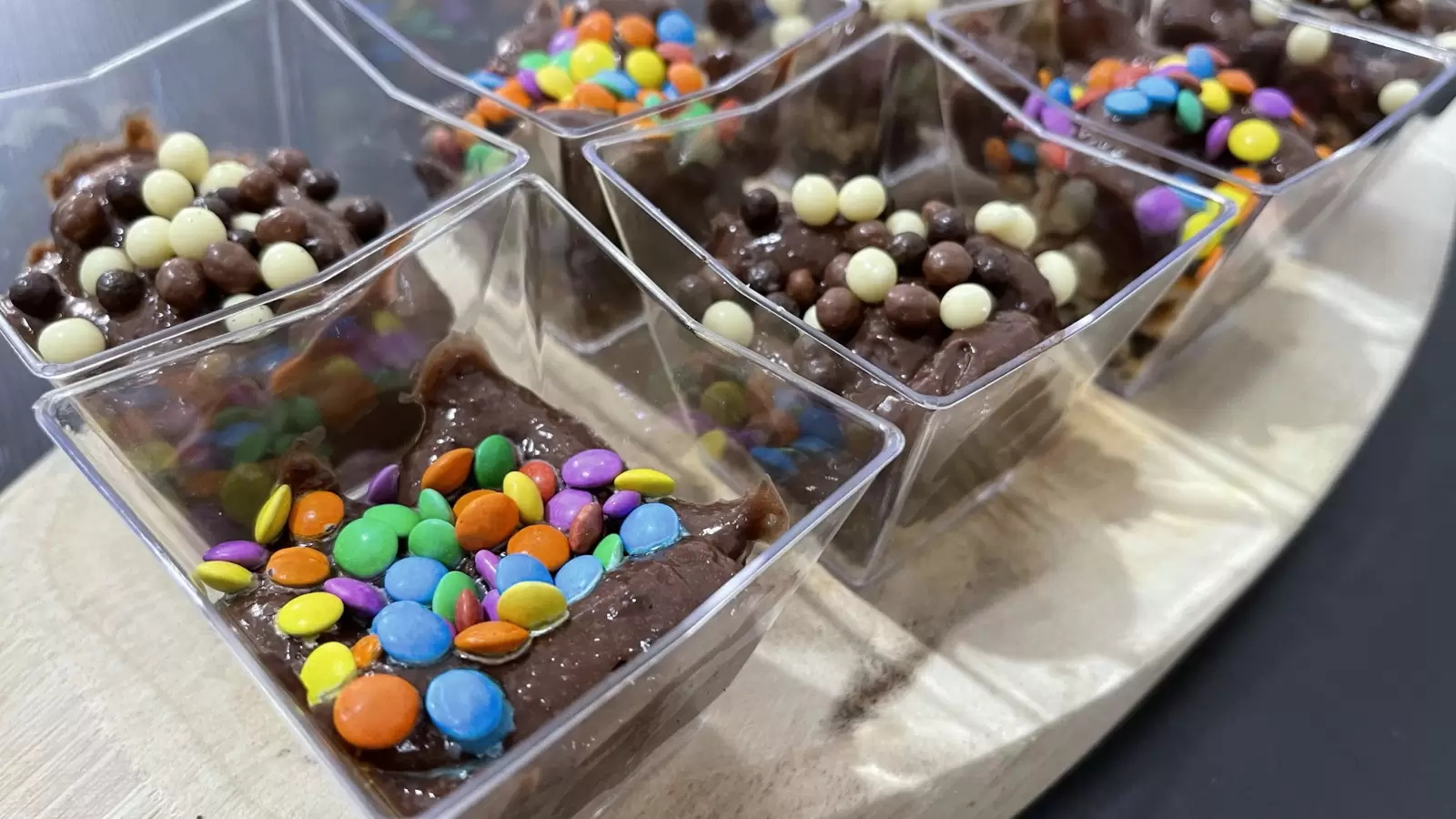Delicious Oreo Pudding Cups on a Wooden Tray