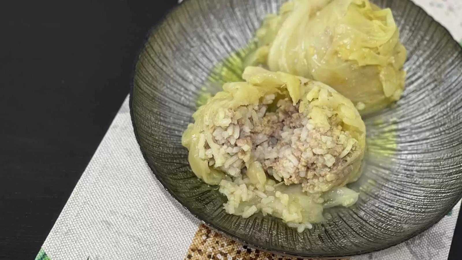 Delicious Stuffed Cabbage With Beef And Rice a plate with the dish a napkin underneath