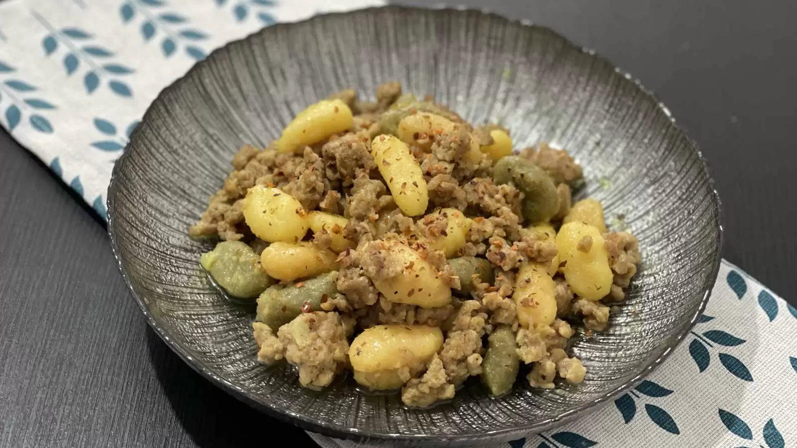 Gnocchi Bolognese on a plate under a napkin