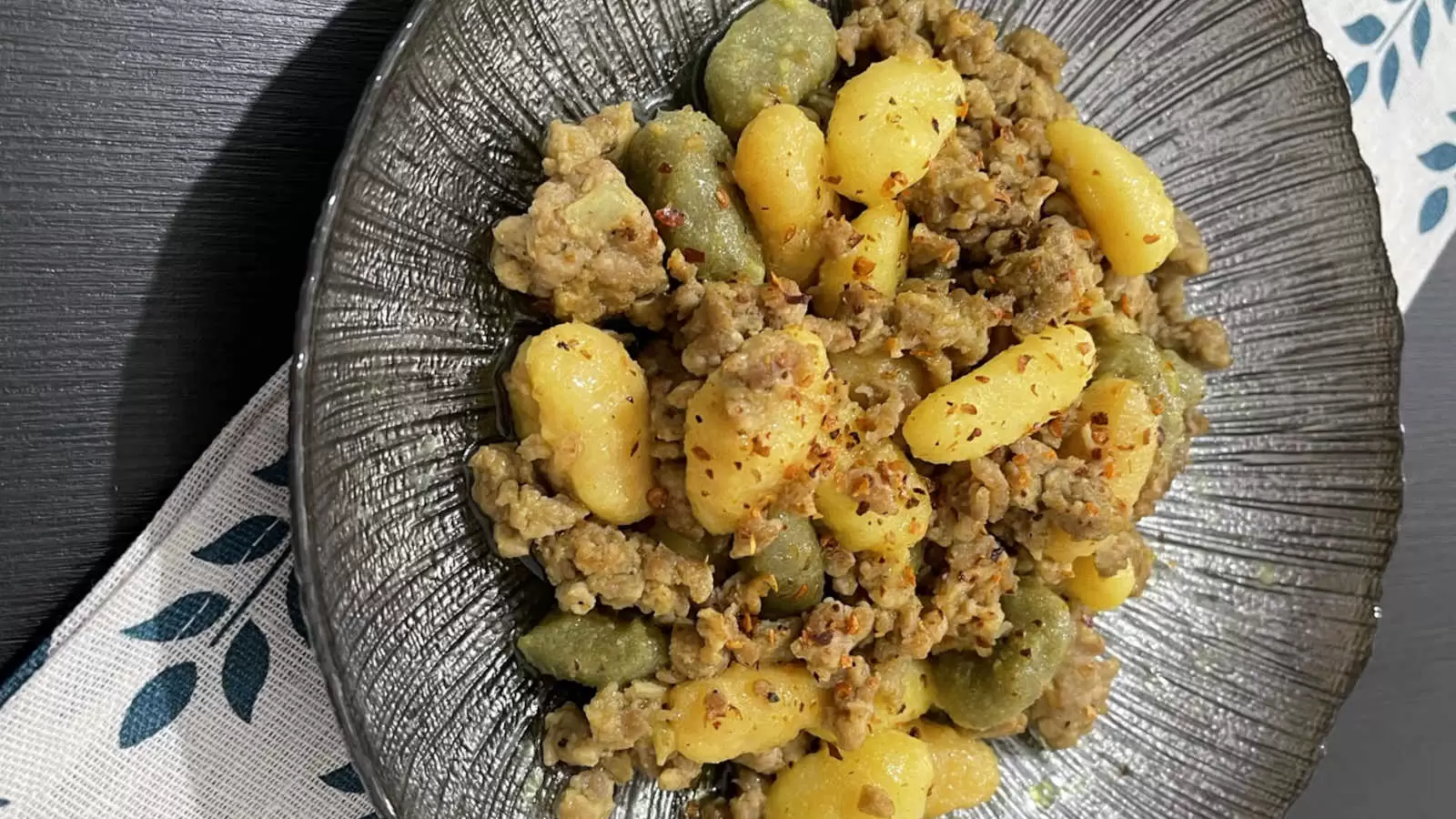 Gnocchi Bolognese Recipe on a plate under a napkin