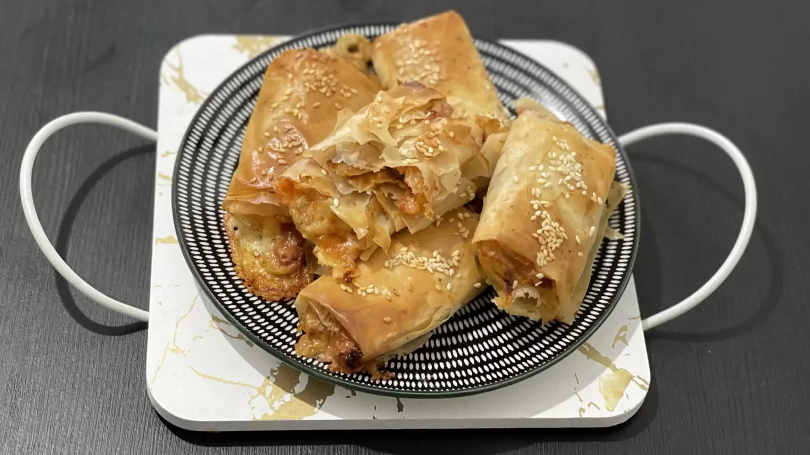 Homemade Filo Pastry Pizza on a plate on a white gold tray