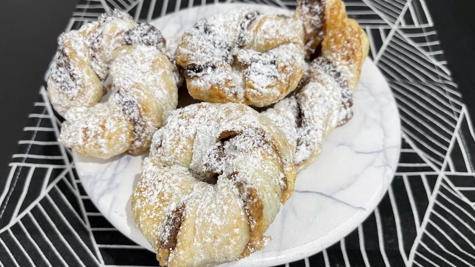 Homemade Kinder Bueno Stuffed Puff Pastry on a plate on a tablecloth