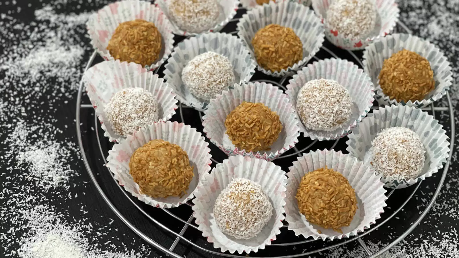 Homemade Milk Jam Balls with Biscuits on a grid coconut flakes scattered on the table