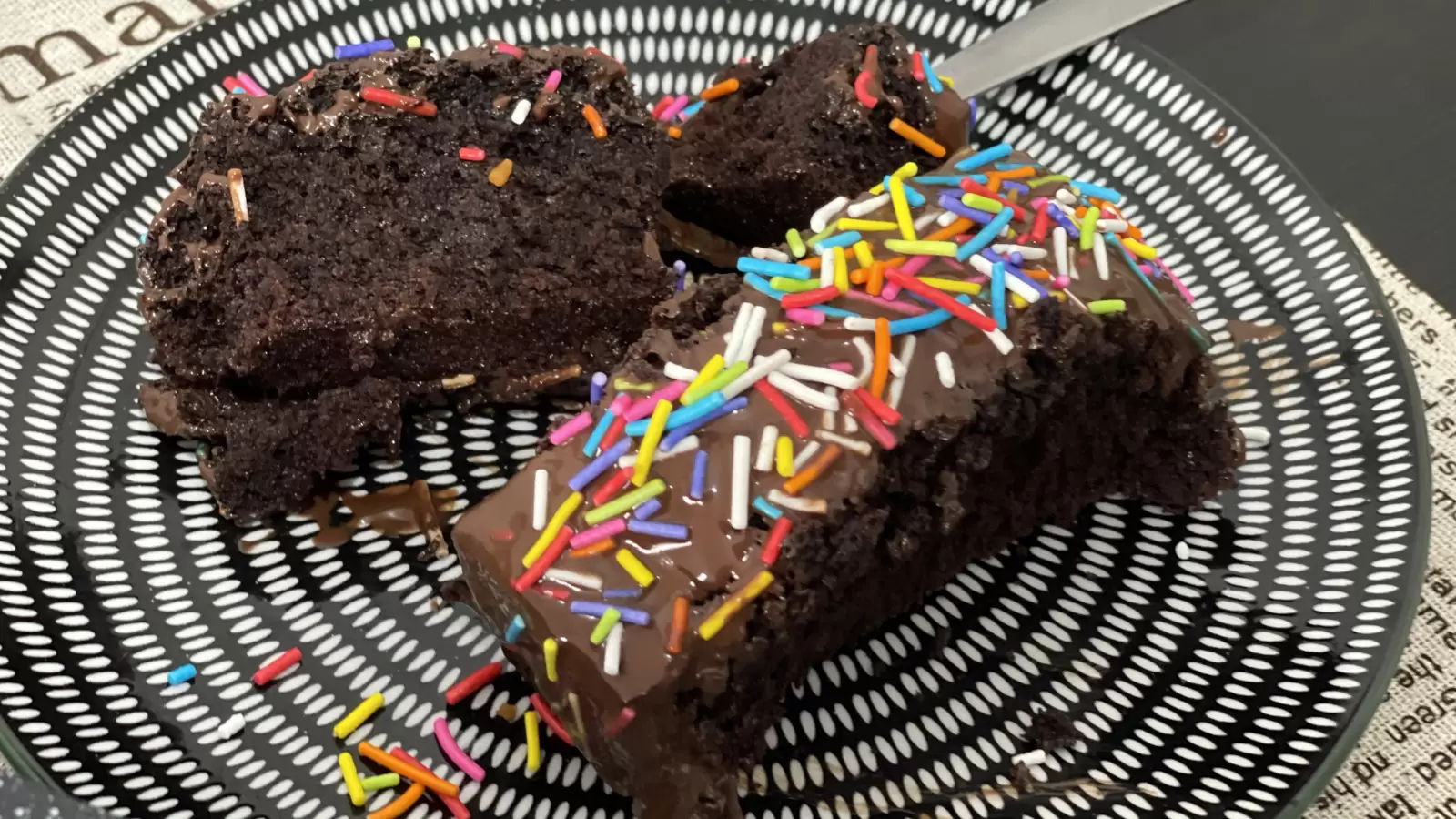 Two pieces of soft chocolate cake on a plate