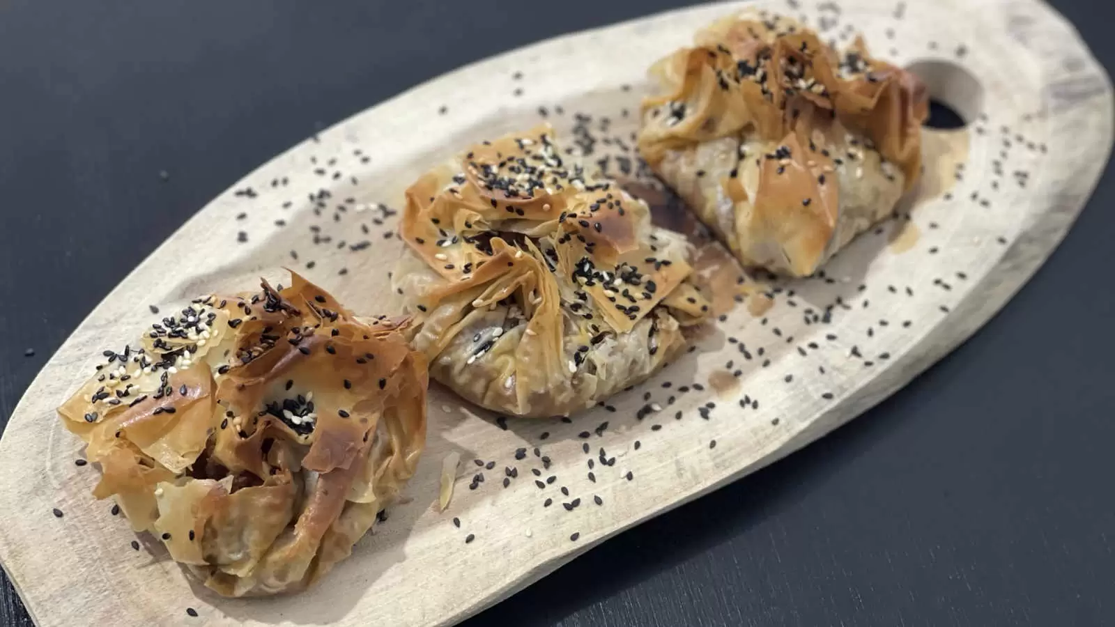 Three Homemade Phyllo Dough Beef Pie on a wooden board