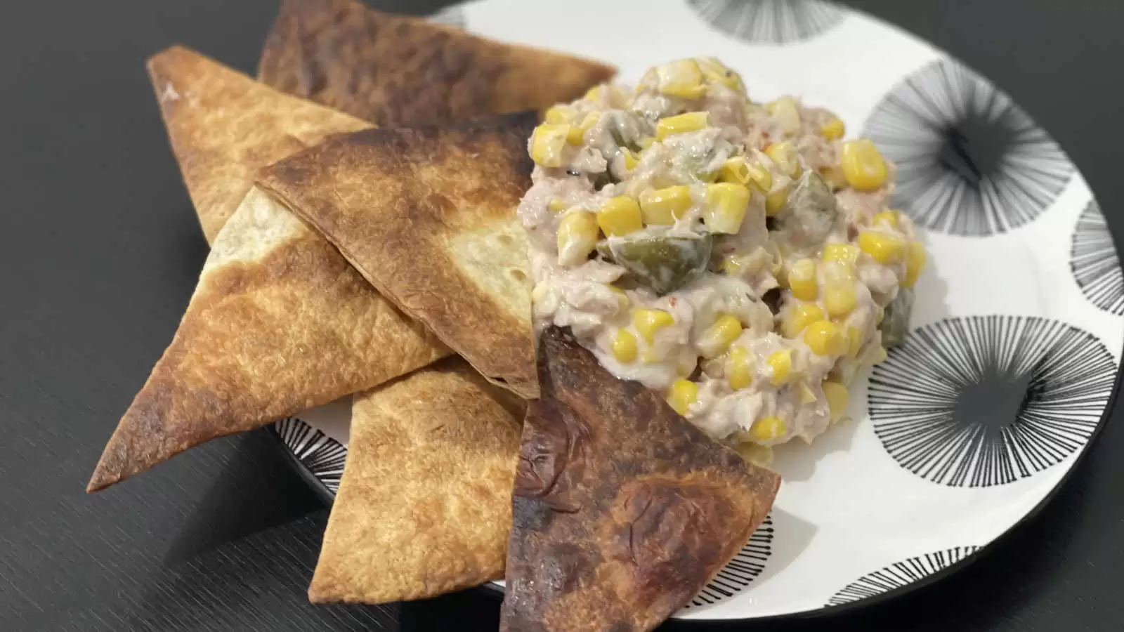 Homemade Tuna corn and mayonnaise salad on a plate and tortilla triangles