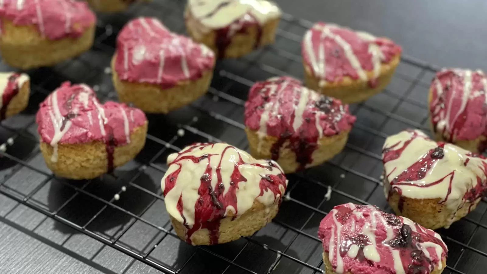 Homemade Vanilla and berry cupcakes on a cooling rack