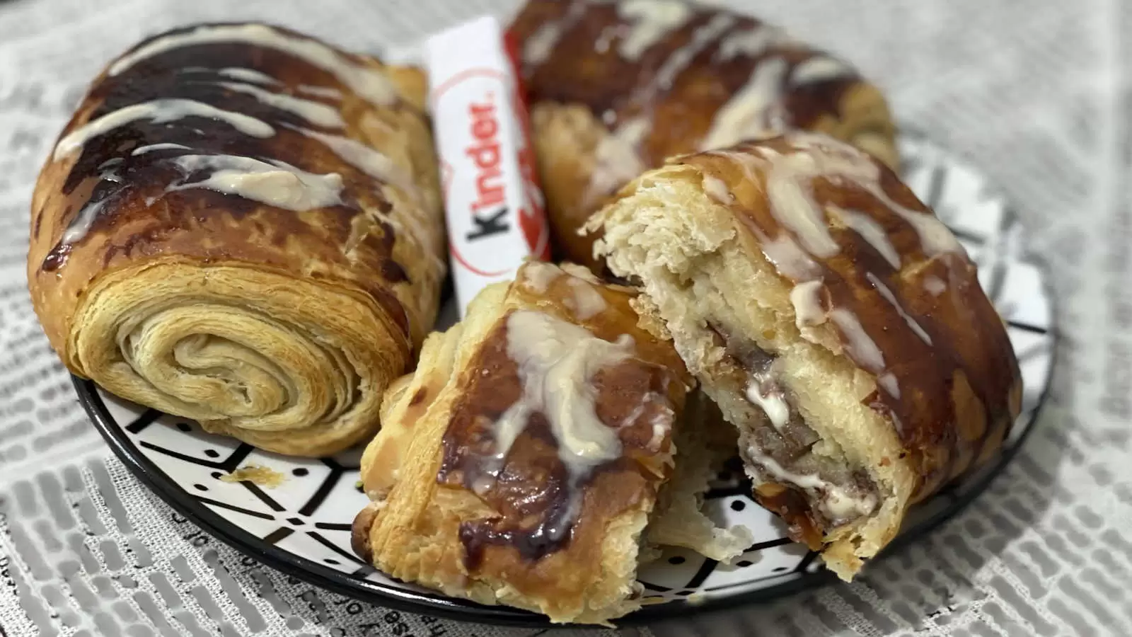 Kinder Bueno Croissant on a plate Kinder Bueno chocolate in the middle napkin underneath