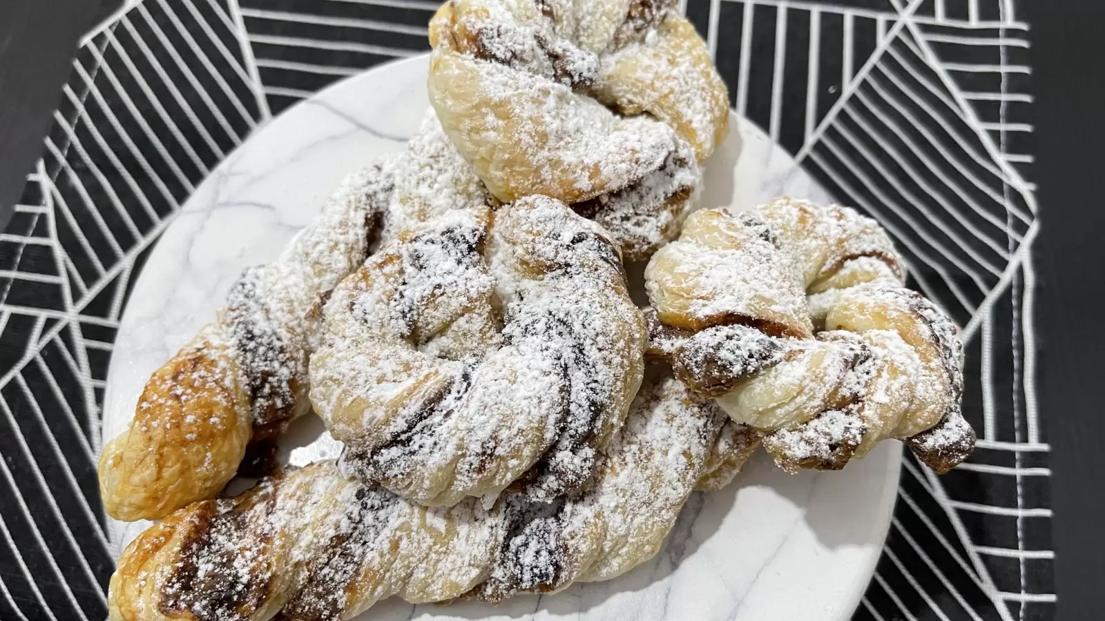 Kinder Bueno Stuffed Puff Pastry dish on a plate on a tablecloth