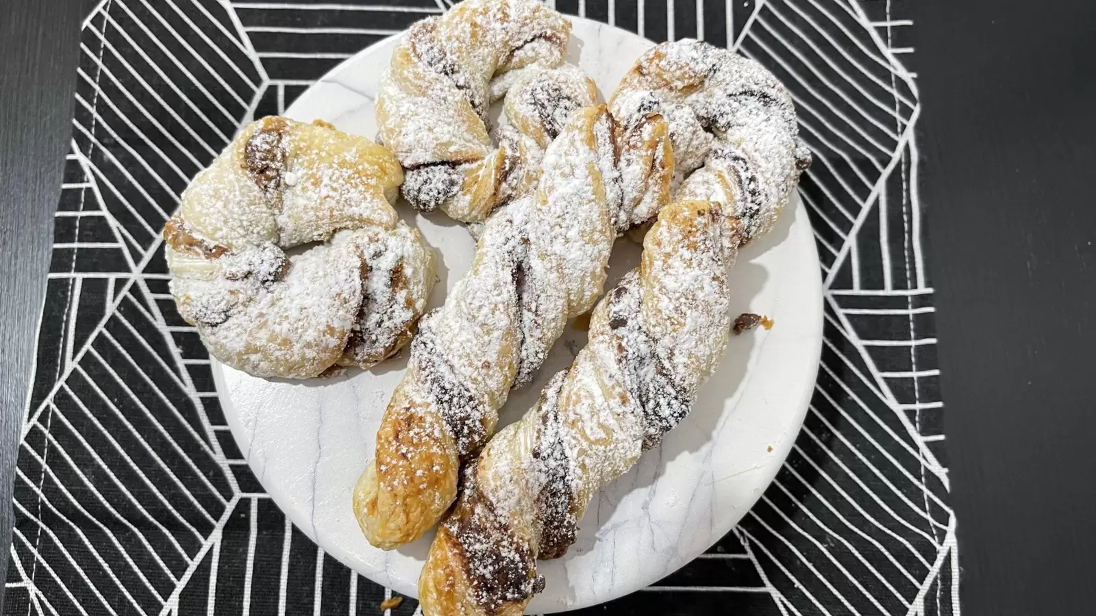Kinder Bueno Stuffed Puff Pastry Recipe on a plate on a tablecloth