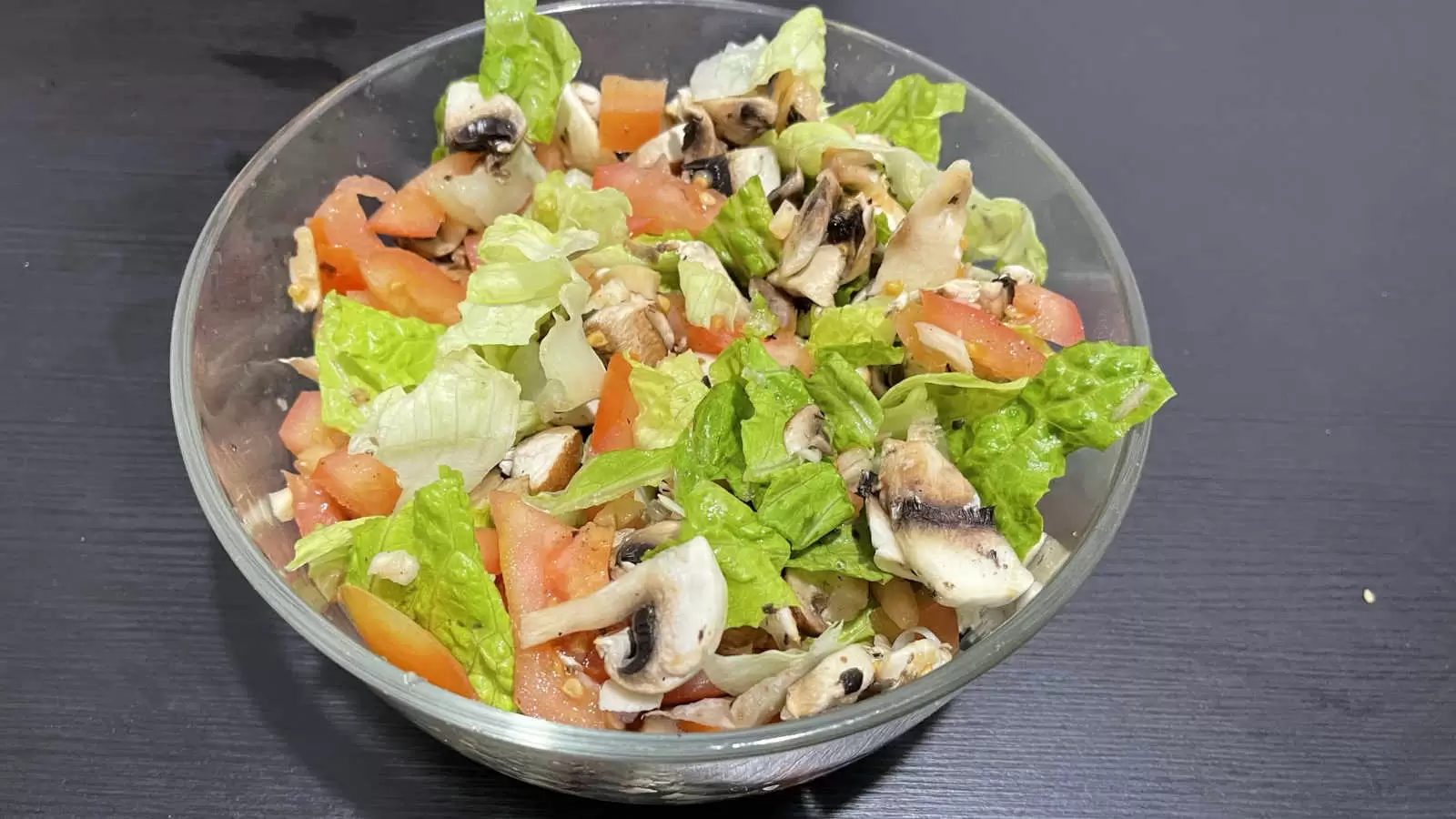 Lettuce tomato mushroom salad in a bowl