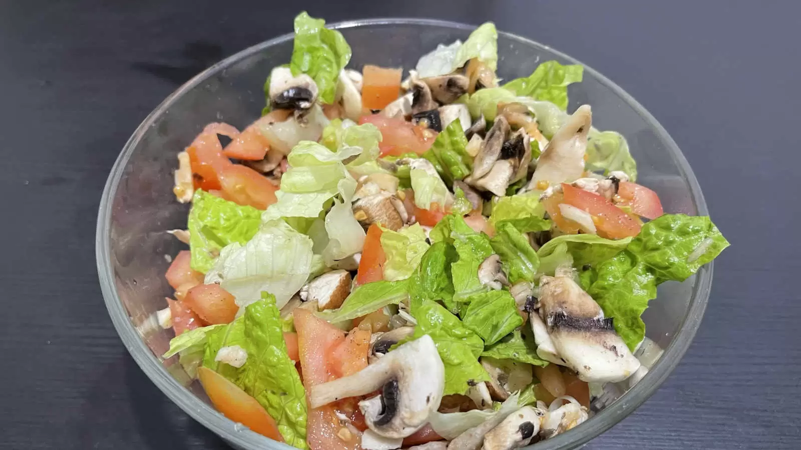 Lettuce tomato mushroom salad dish in a bowl