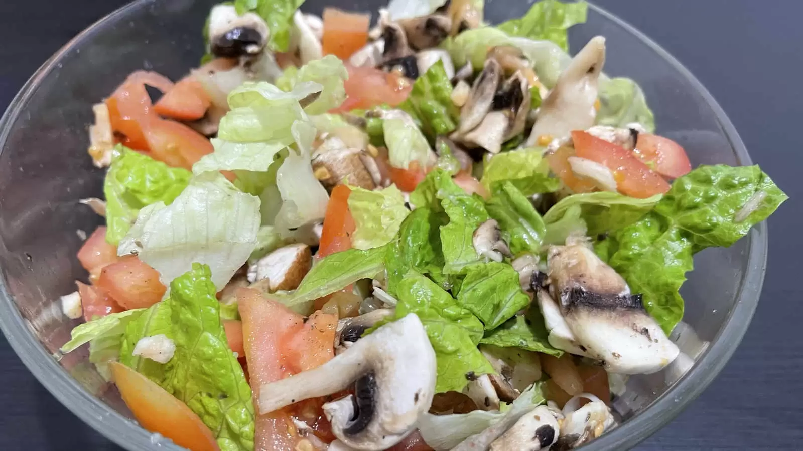 Lettuce tomato mushroom salad meal in a bowl