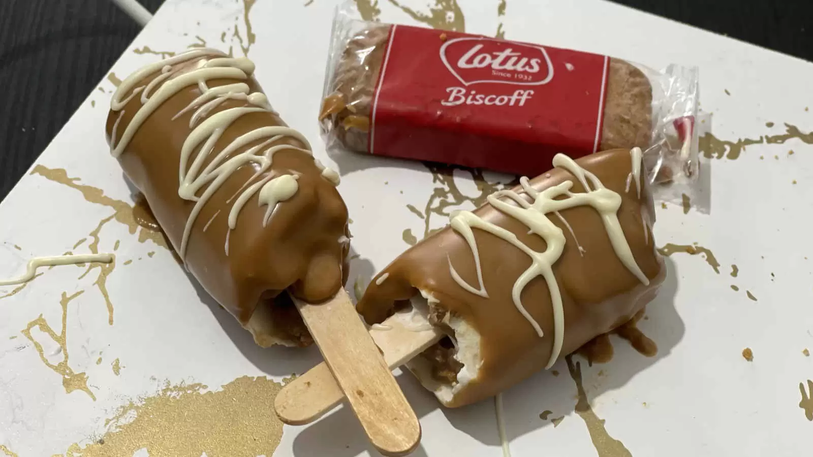 Two Lotus ice creams a Lotus Biscoff cookie on a tray