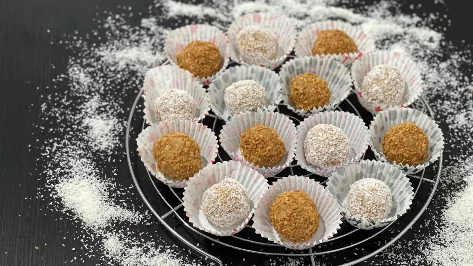 Milk Jam Balls with Biscuits dish on a grid coconut flakes scattered on the table