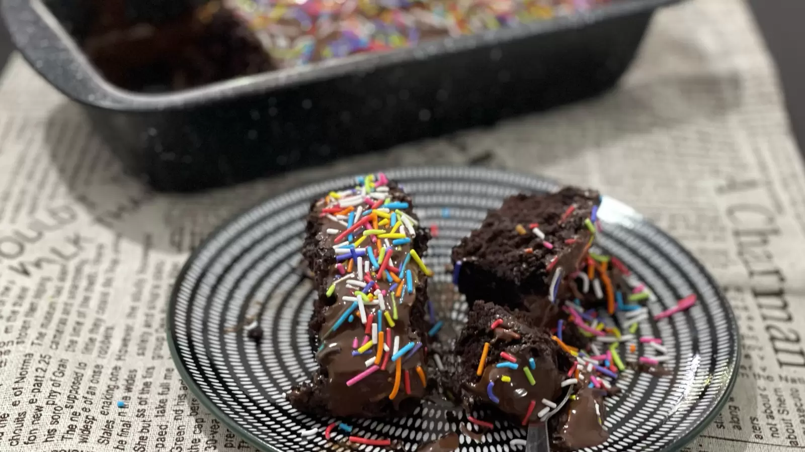 Two pieces of soft chocolate cake dish on a plate a mold with chocolate cake