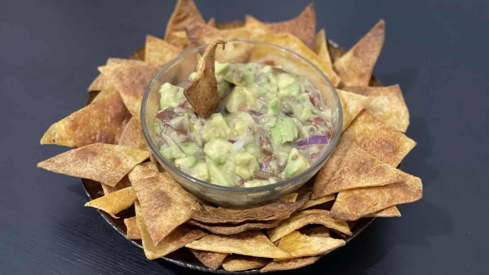 Nachos and guacamole on a plate