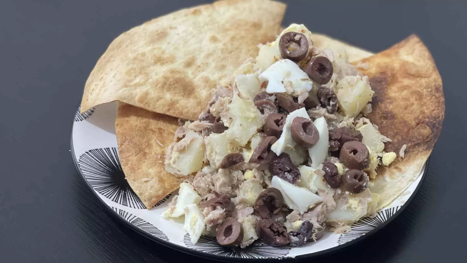 Nisoise salad and tortilla triangles on a plate