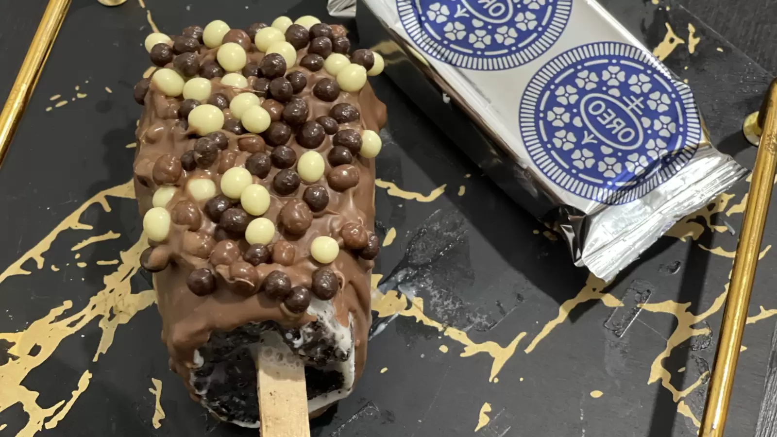 Homemade Oreo ice cream recipe a package of Oreo cookies on a tray