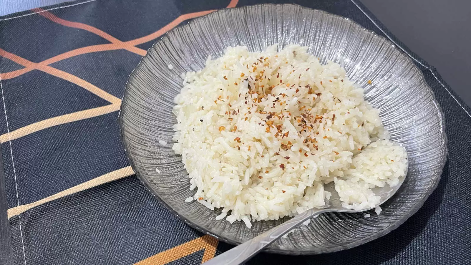 Rice recipe on a plate with a spoon under a napkin