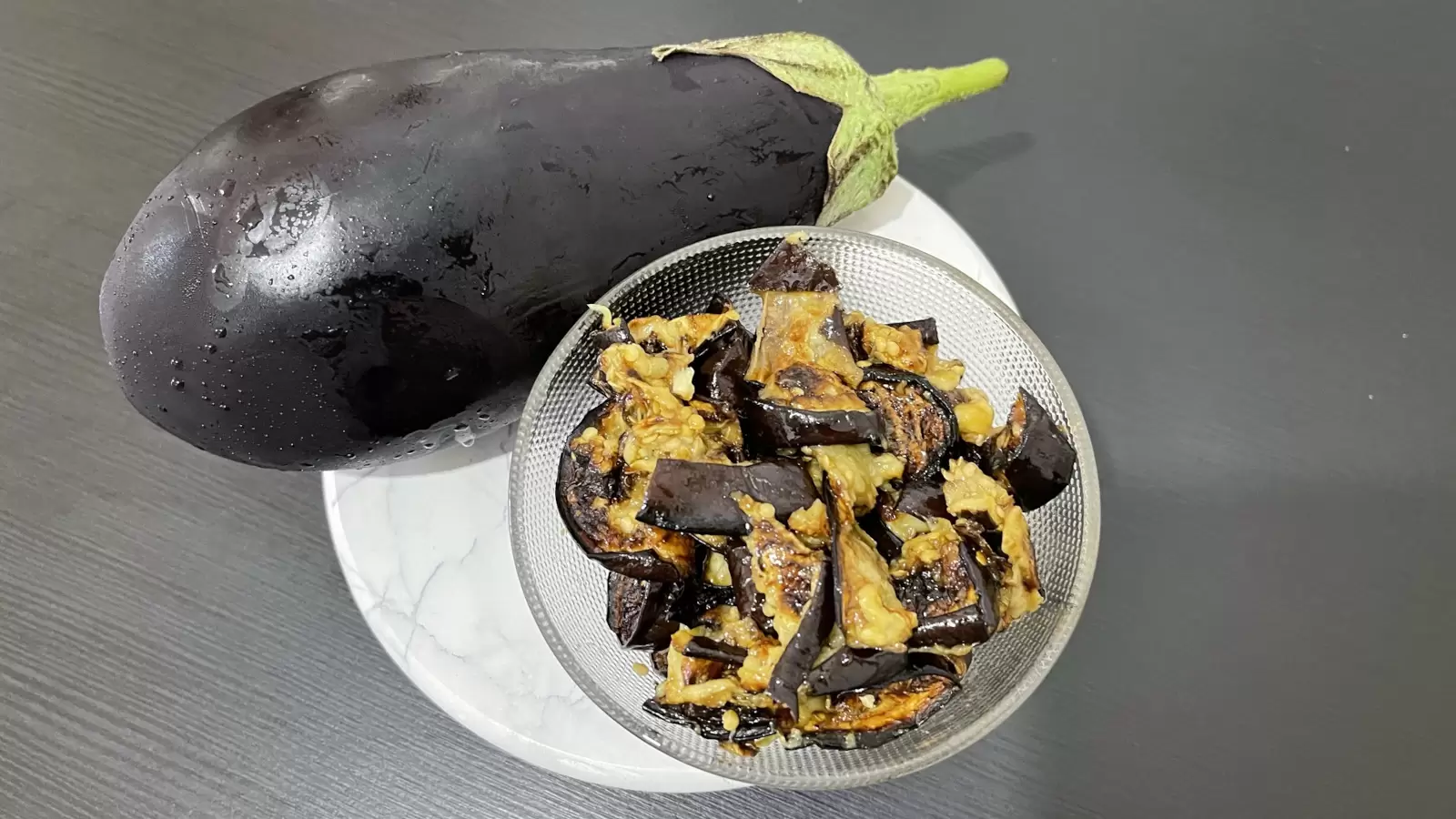 eggplant salad next to it in a bowl on a tray on the table