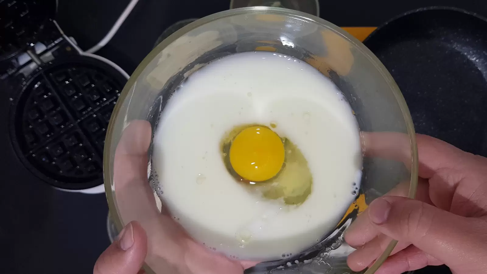 A bowl with egg, milk, water and oil