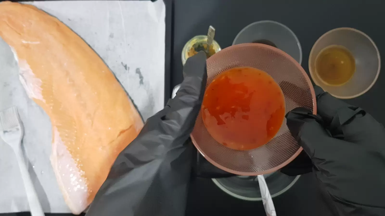 Bowl with sweet chili, bowl with honey, baking dish with salmon and brush