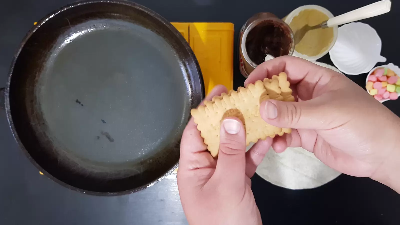 Pan, biscuits, jar of white chocolate, jar of Nutella chocolate, marshmallow bowl