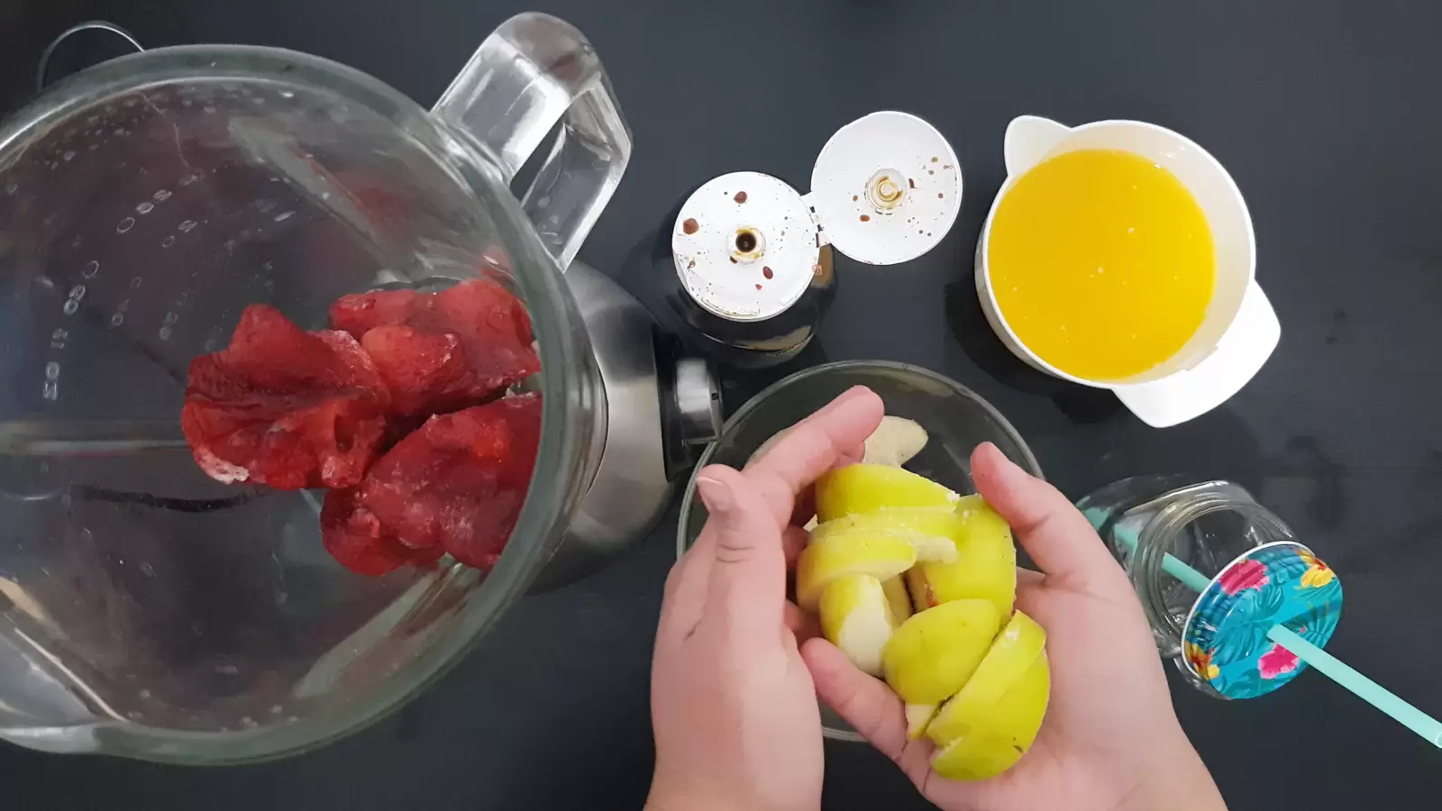 Orange juice in a juicer, strawberries in a blender, apples, a glass