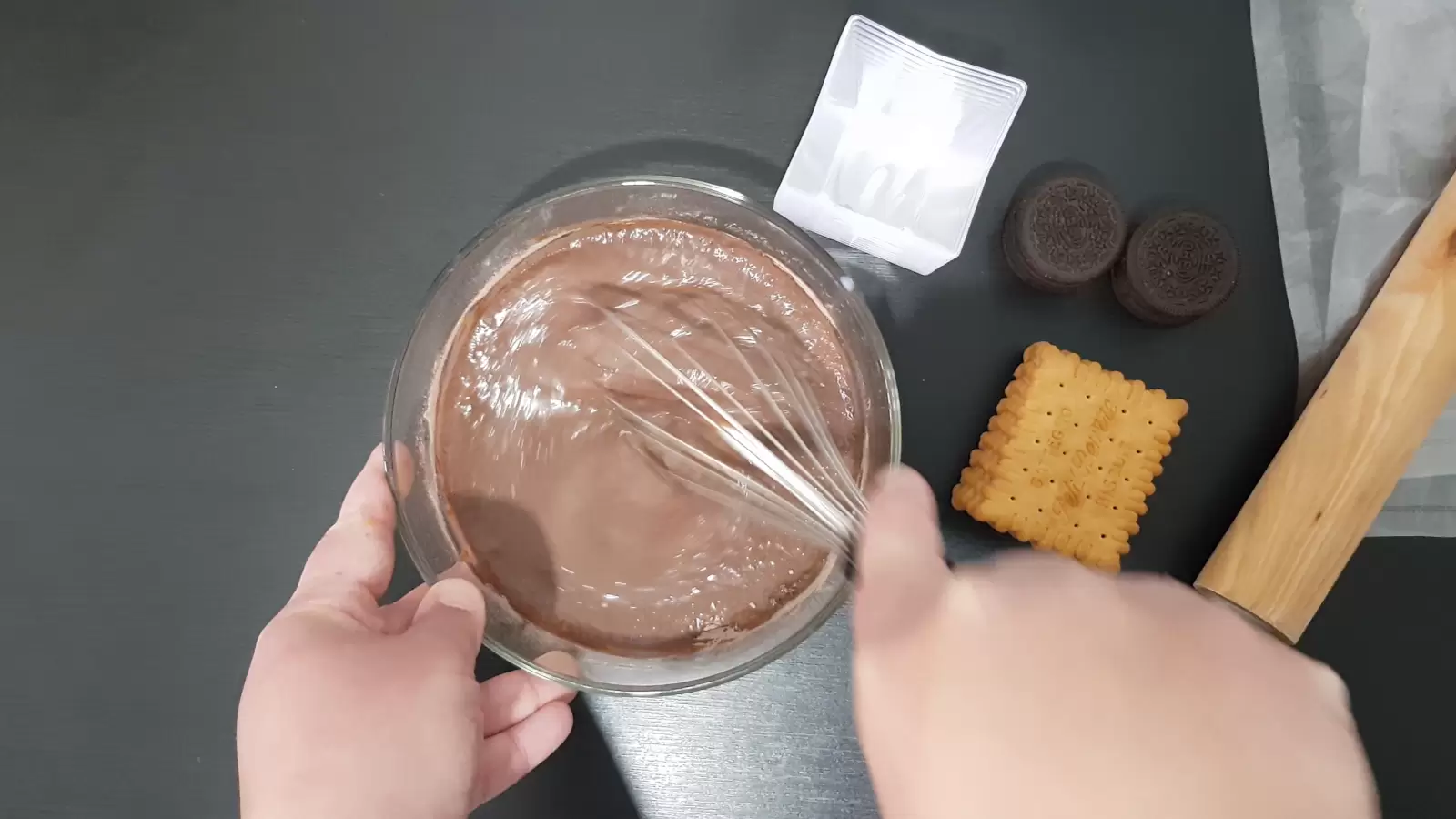 Rolling wheel, biscuits, Oreo cookies, bowl with pudding and whisk