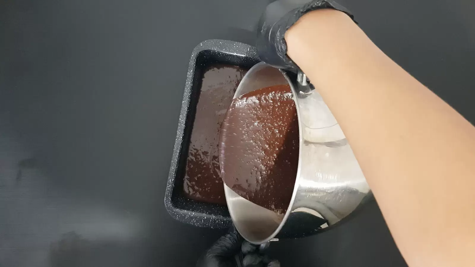 Mixer bowl poured with batter into English cake pan