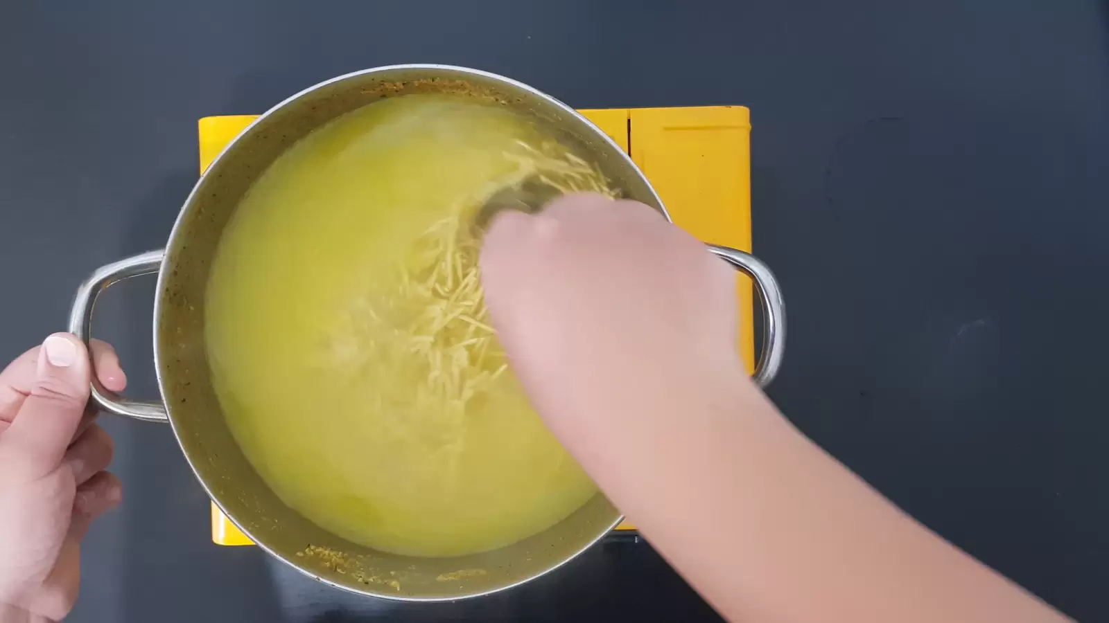 Pot with soup and noodles