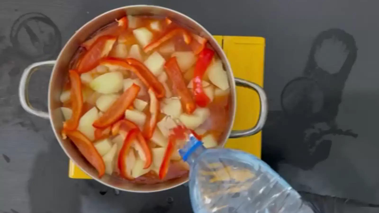 Pot with potatoes, red pepper, bottle of water