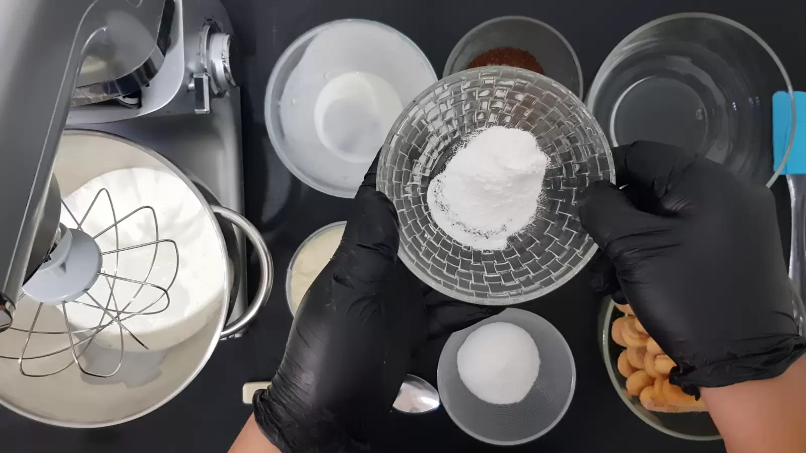Bowl with water, bowl of coffee and sugar, bowl with ladyfingers, bowl with sugar, mixer bowl with cream and whipping balloon