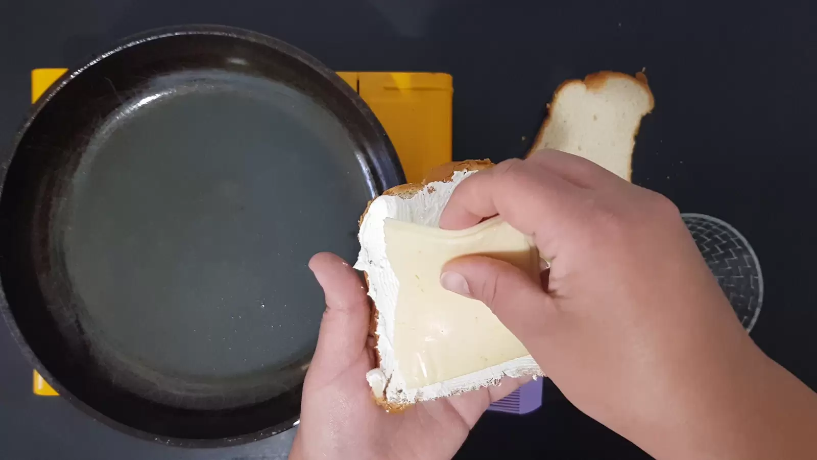 A slice of cheese on a slice of bread. pan.