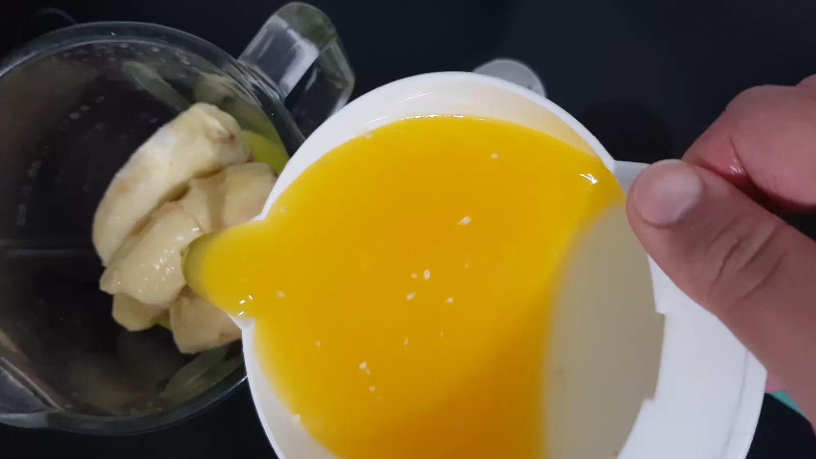 Orange juice in a juicer, bananas in a blender