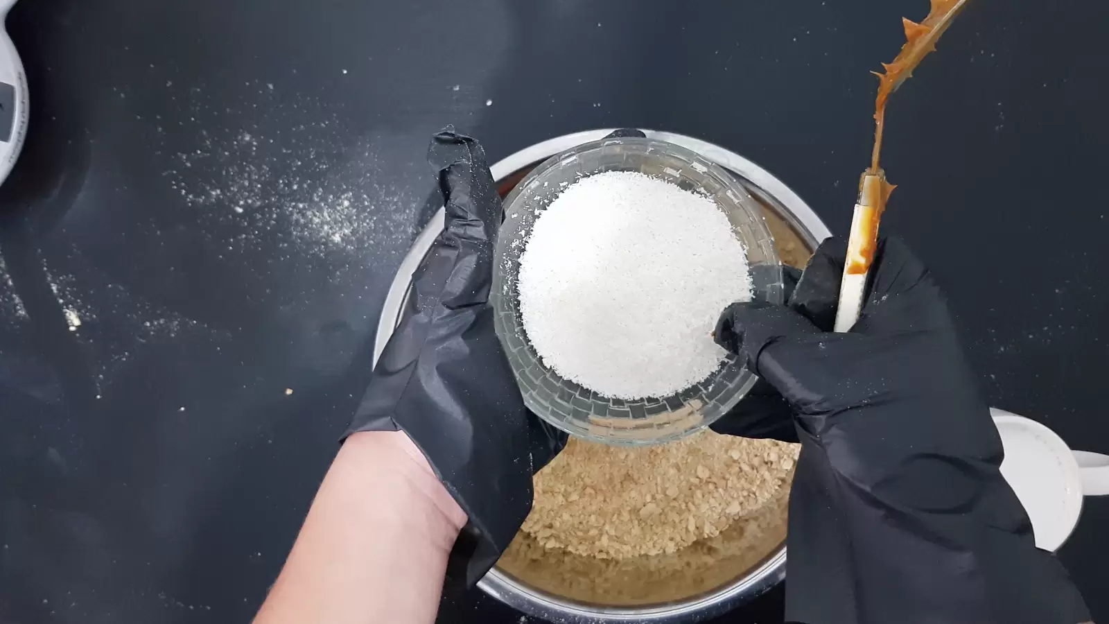 A bowl of coconut, a bowl of ground biscuits