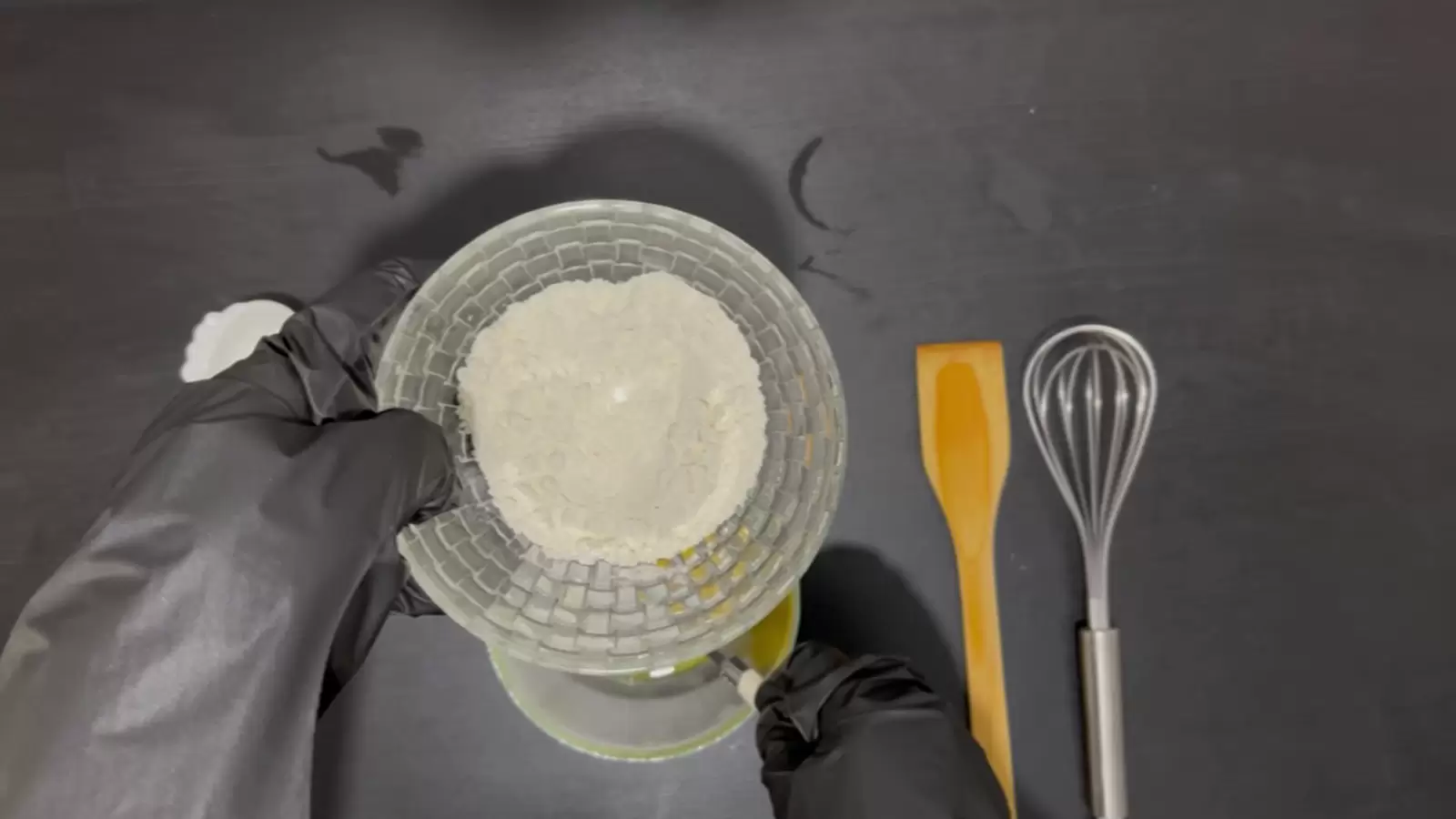 Bowl with flour, whisk, wooden spoon