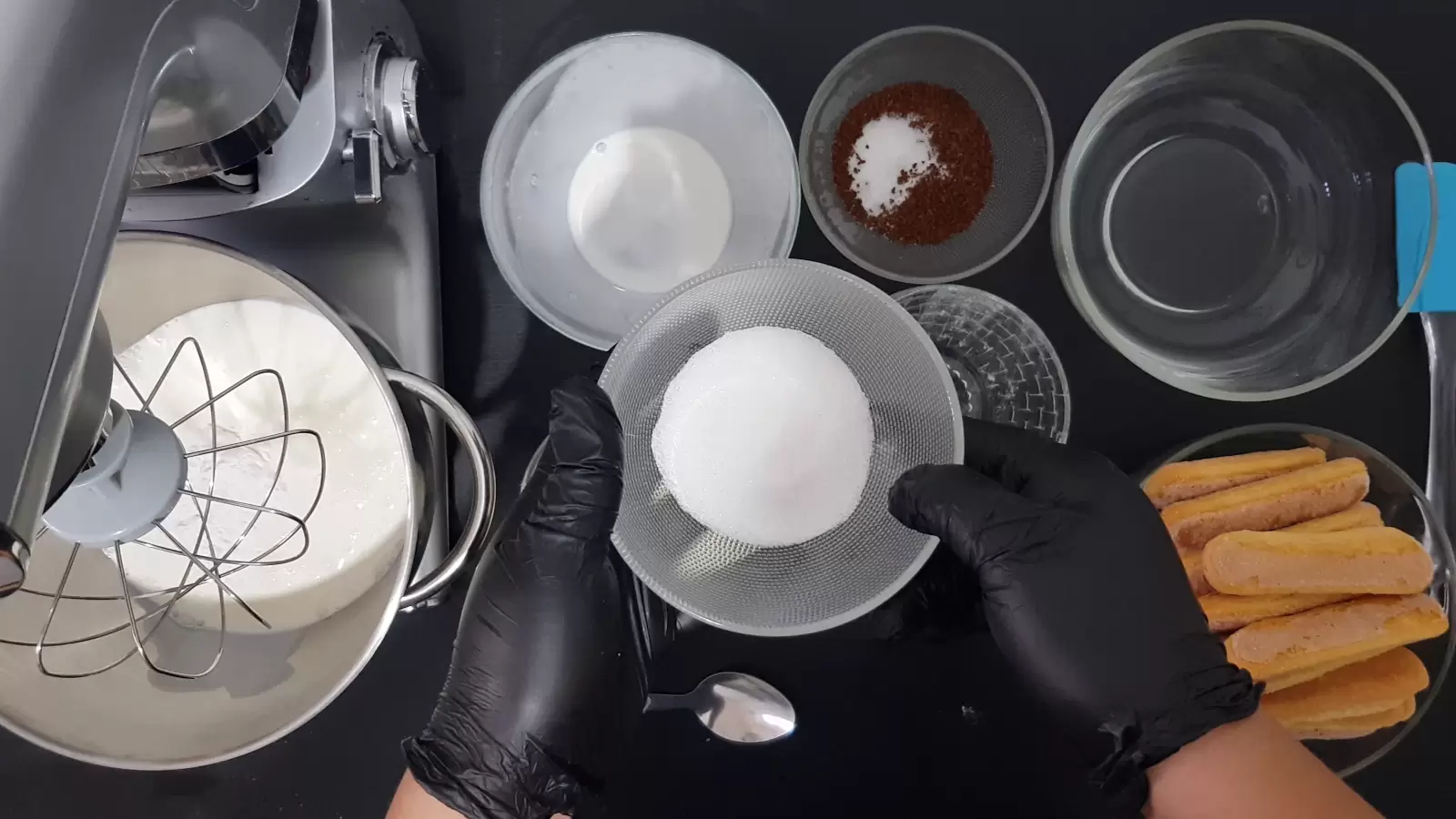 Bowl with water, bowl of coffee and sugar, bowl with ladyfingers, bowl with sugar, mixer bowl with cream and whipping balloon