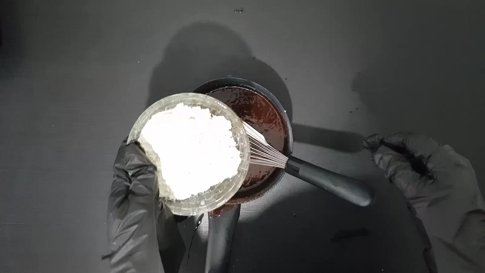 Bowl with chocolate batter, bowl with flour